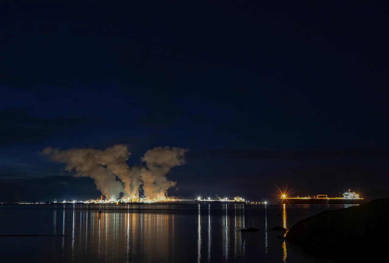 A lit oil refinery at night